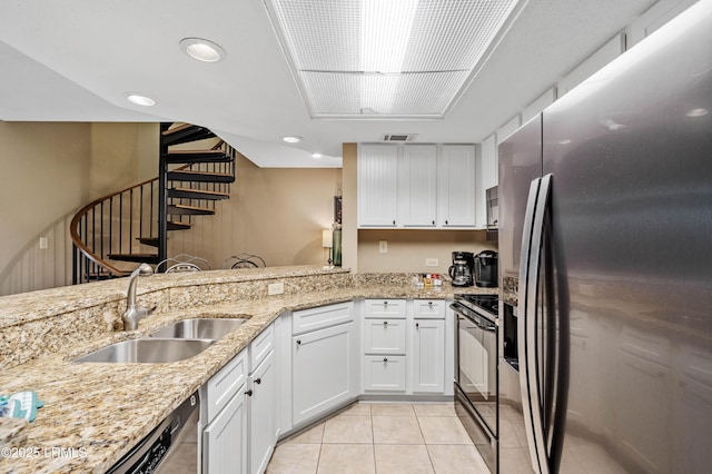 13 Harbourside Ln Unit 7170, Hilton Head Island, SC 29928 - kitchen with a sink, stainless steel appliances, light tile patterned floors, white cabinets, and recessed lighting