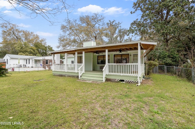 156 James St, Beaufort, SC 29902 - view of front of home featuring a ceiling fan, a front lawn, a porch, fence, and a chimney
