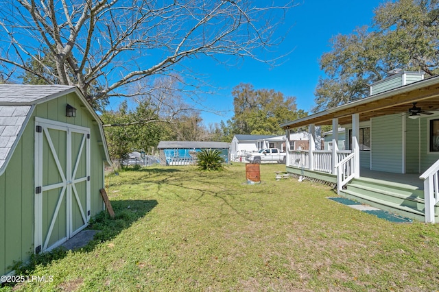 view of yard with a porch, a storage unit, and an outdoor structure