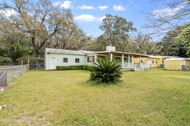 156 James St, Beaufort, SC 29902 - back of house with a yard, covered porch, a fenced backyard, and a chimney