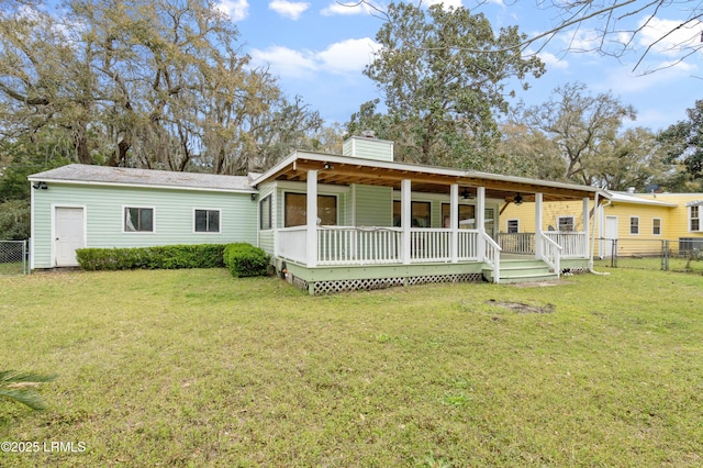 156 James St, Beaufort, SC 29902 - rear view of house featuring a ceiling fan, a lawn, a chimney, and fence