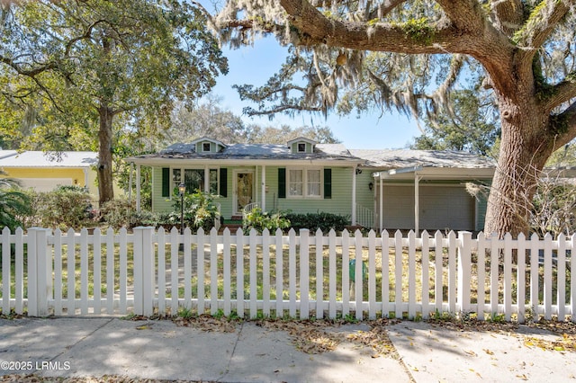 view of front of home featuring a fenced front yard and a garage