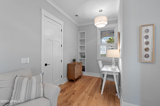 office with crown molding and light hardwood / wood-style floors