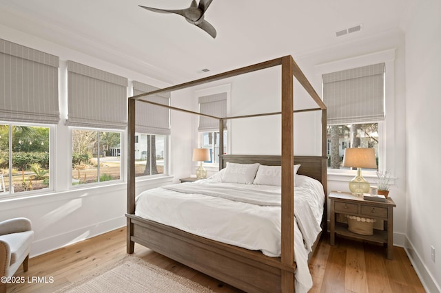 bedroom with light hardwood / wood-style flooring and ceiling fan