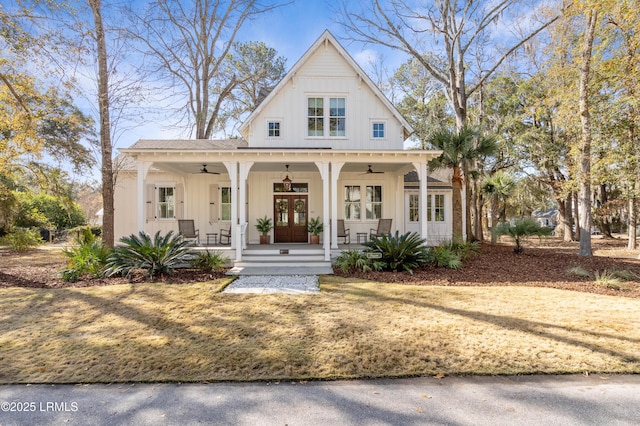 modern inspired farmhouse with a front yard, french doors, ceiling fan, and a porch