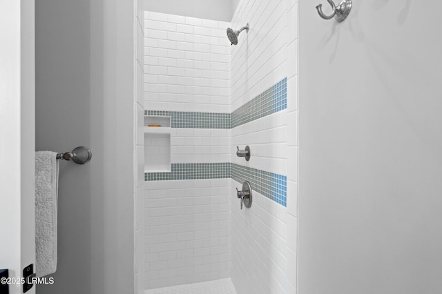 bathroom with tiled shower