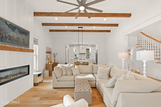 living room featuring plenty of natural light, a chandelier, and light hardwood / wood-style floors