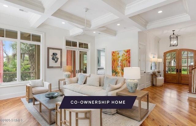 living room with beam ceiling, coffered ceiling, french doors, and light wood finished floors