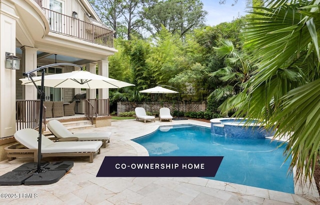 view of pool with a pool with connected hot tub, a patio, and fence