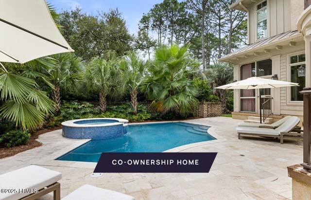 view of pool featuring a patio, entry steps, and a pool with connected hot tub