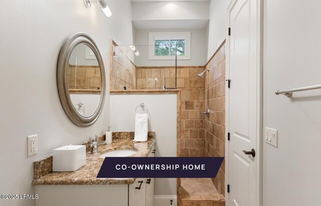 full bathroom featuring vanity and walk in shower