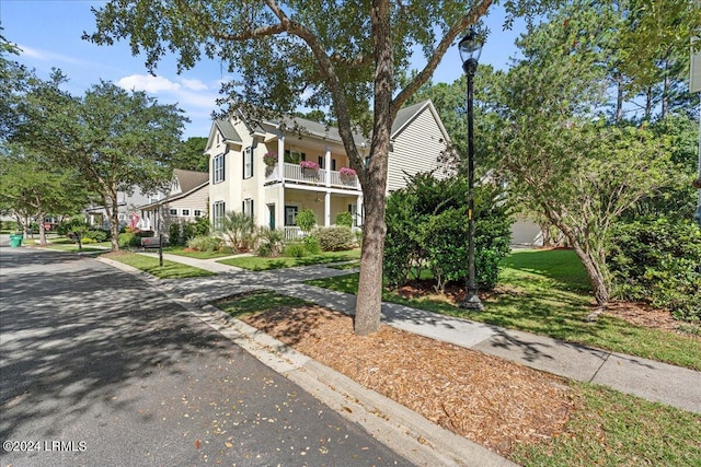 21 Woods Bay Rd, Bluffton, SC 29910 - view of front of house with a balcony, stucco siding, and a front yard