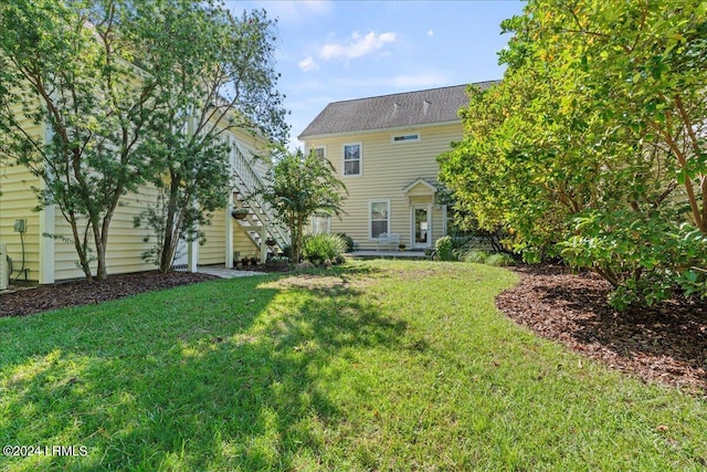 21 Woods Bay Rd, Bluffton, SC 29910 - back of house featuring a yard and stairway