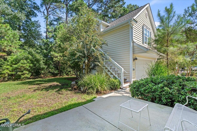 21 Woods Bay Rd, Bluffton, SC 29910 - view of side of home featuring stairway, a garage, a patio, and roof with shingles