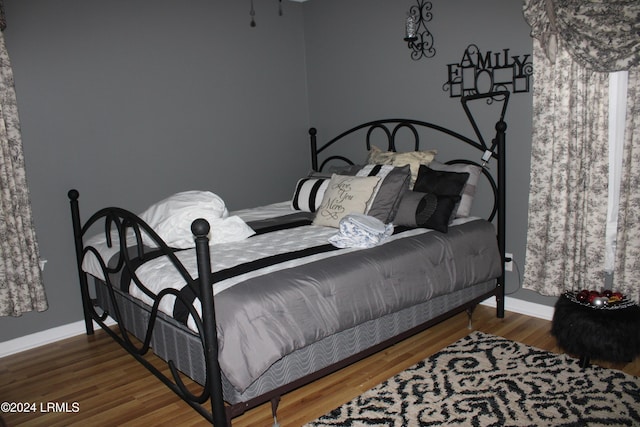 bedroom with hardwood / wood-style floors