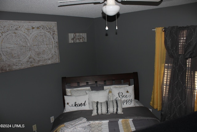 bedroom with a textured ceiling and ceiling fan