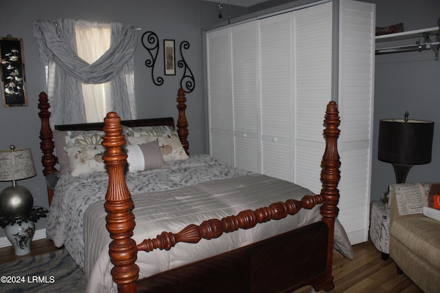 bedroom featuring wood-type flooring and a closet