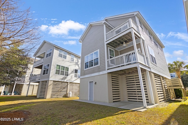 view of front facade with a front lawn and a balcony