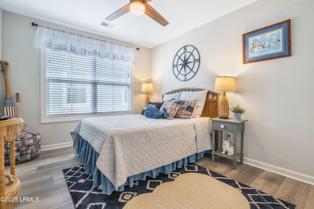 bedroom with ceiling fan and hardwood / wood-style floors