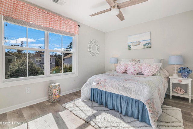 bedroom with hardwood / wood-style flooring and ceiling fan