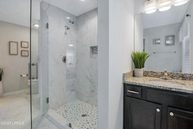 bathroom featuring vanity, toilet, and a shower with door