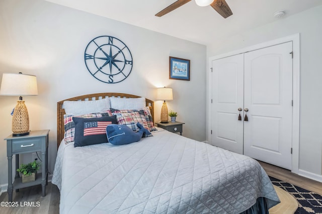 bedroom with ceiling fan, dark hardwood / wood-style flooring, and a closet