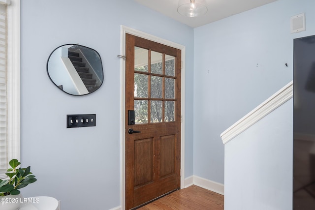 entrance foyer featuring wood finished floors, visible vents, and baseboards