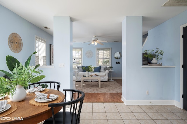 dining area with a wealth of natural light, light tile patterned flooring, and visible vents