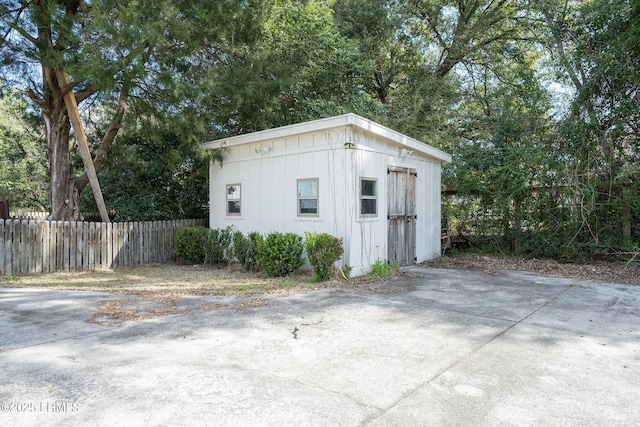 view of outbuilding featuring an outbuilding and fence