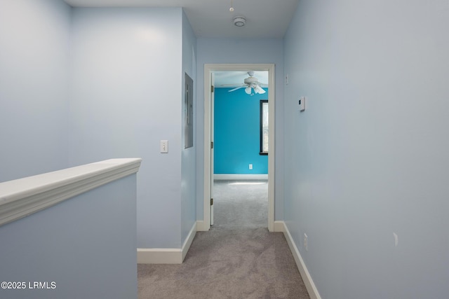 hallway with carpet flooring and baseboards