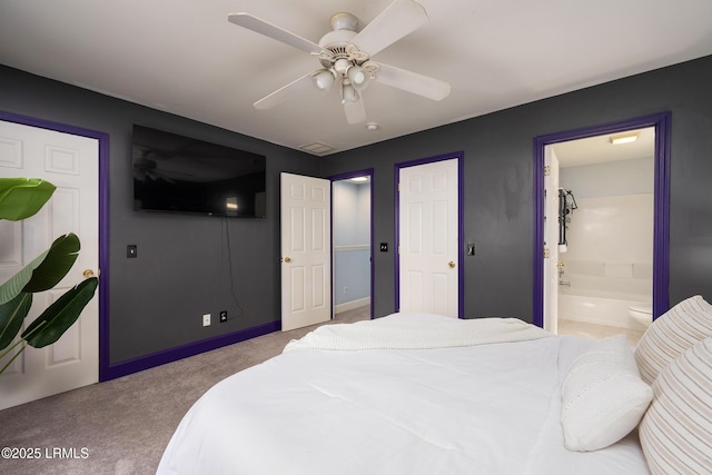 bedroom featuring carpet floors, baseboards, a ceiling fan, and ensuite bathroom