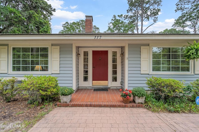 117 Elliott St, Beaufort, SC 29902 - view of front of property featuring fence, a patio, and a chimney