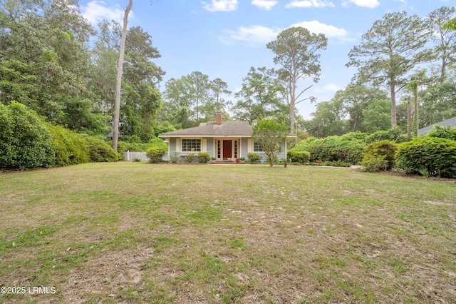117 Elliott St, Beaufort, SC 29902 - view of front facade featuring a front lawn and a chimney