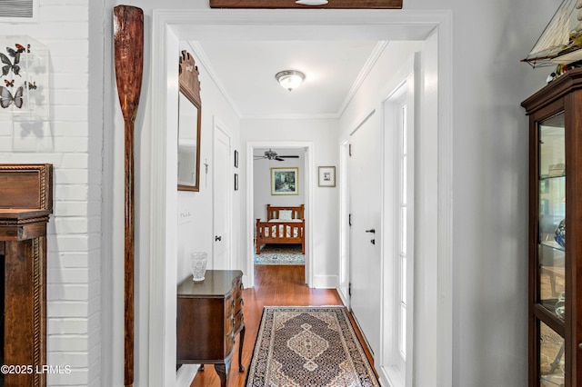 117 Elliott St, Beaufort, SC 29902 - corridor with dark wood finished floors, ornamental molding, and baseboards