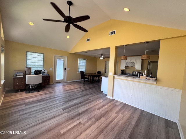 kitchen with pendant lighting, open floor plan, under cabinet range hood, and wood finished floors