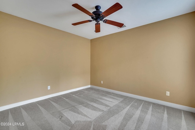 spare room with ceiling fan and carpet