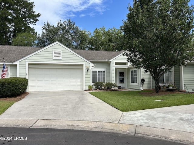 single story home featuring a garage and a front yard