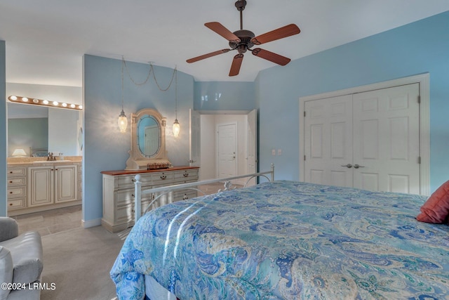 carpeted bedroom with ceiling fan, sink, and a closet