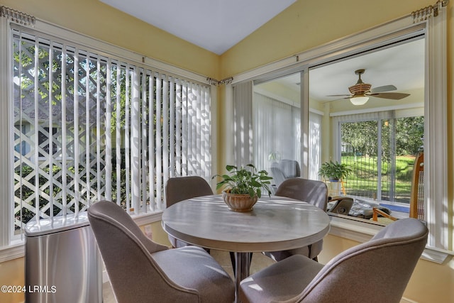 sunroom / solarium featuring ceiling fan, vaulted ceiling, and a healthy amount of sunlight