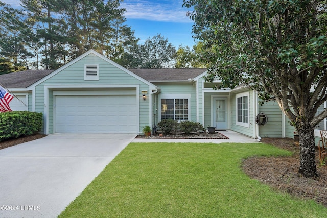 single story home with a garage and a front lawn