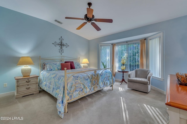 bedroom with ceiling fan, vaulted ceiling, and light carpet