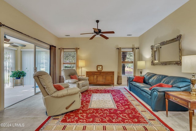 carpeted living room with ceiling fan and a wealth of natural light