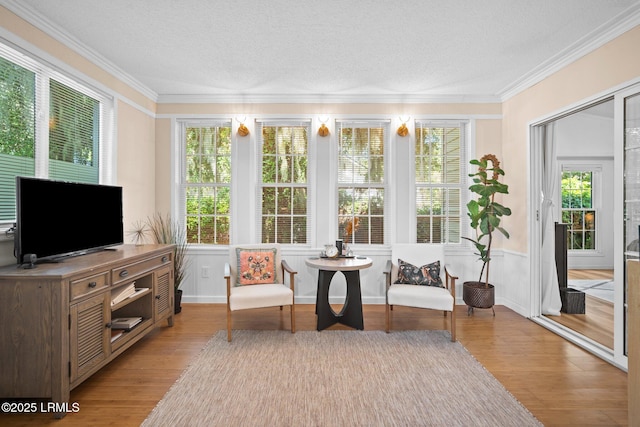 3 Stono Ct, Beaufort, SC 29902 - sunroom with wood finished floors, crown molding, a textured ceiling, and a wainscoted wall