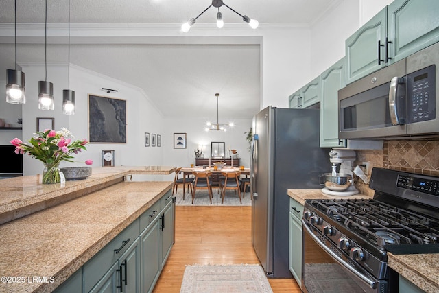 3 Stono Ct, Beaufort, SC 29902 - kitchen featuring stainless steel appliances, tasteful backsplash, hanging light fixtures, vaulted ceiling, and light wood-style flooring