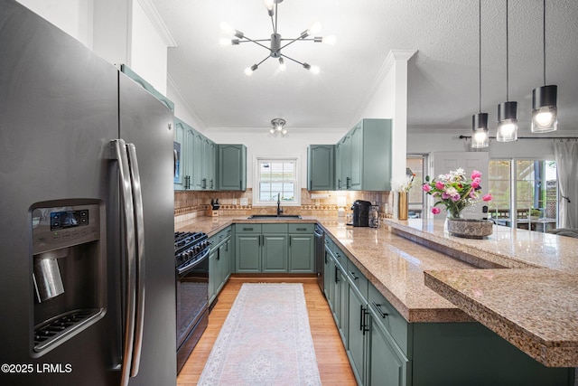 3 Stono Ct, Beaufort, SC 29902 - kitchen with stainless steel appliances, a sink, a peninsula, green cabinets, and crown molding