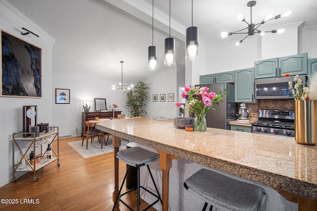 3 Stono Ct, Beaufort, SC 29902 - kitchen featuring stainless steel appliances, a chandelier, light wood-type flooring, a breakfast bar area, and ornamental molding