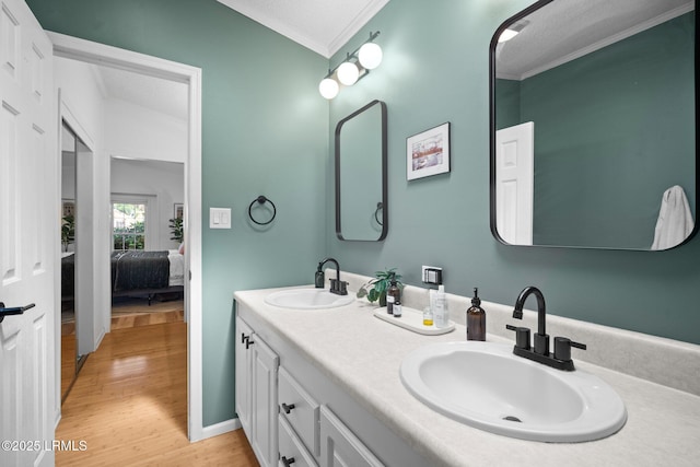 3 Stono Ct, Beaufort, SC 29902 - full bathroom featuring ornamental molding, wood finished floors, double vanity, connected bathroom, and a textured ceiling