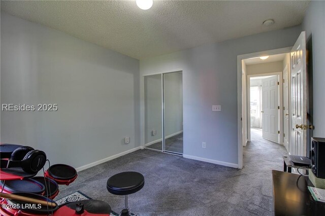 55 Broadland Cir, Bluffton, SC 29910 - unfurnished bedroom featuring dark carpet, a textured ceiling, and a closet