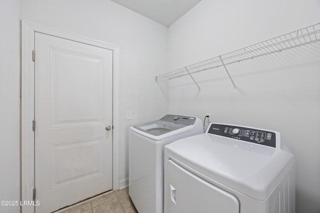 227 Wooden Wheel Ln, Okatie, SC 29909 - laundry room featuring washer and clothes dryer, light tile patterned floors, and baseboards