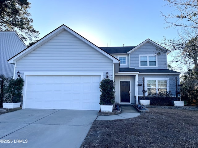 view of front facade with concrete driveway and a garage